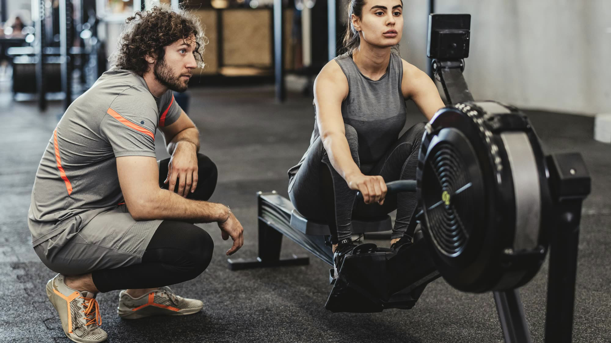 A woman at the catch position on a Concept2 RowErg.